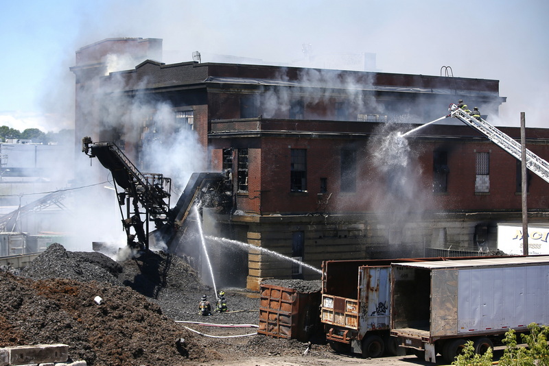 New Bedford firefighters battle a multi-alarm fire at Bob's Tire Company on Brook Street in New Bedford, MA.  PHOTO PETER PEREIRA