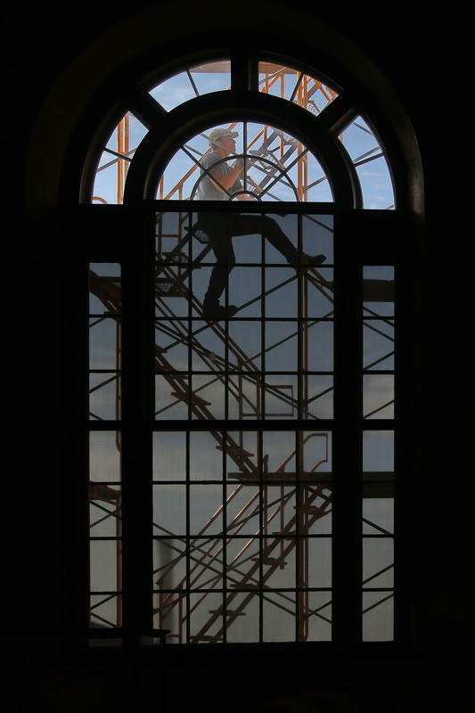 Masons set up the staging on the Union Street facing side of the Whaling Museum in New Bedford, MA before repointing the brickwork, as seen from inside the Lagoda room. PHOTO PETER PEREIRA