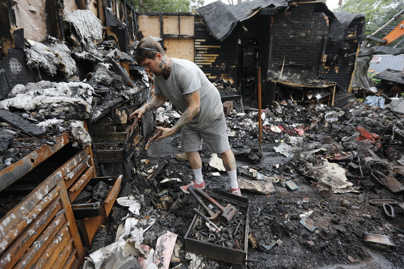 Jon Hodgkins a mechanic at Mattapoisett Power Equipment on Route 6 in Mattapoisett, MA looks to see if any of the tools that were inside of the repair shop are salvageable after the building caught fire last year.  The building is finally being demolished in order to build a new facility.  PHOTO PETER PEREIRA