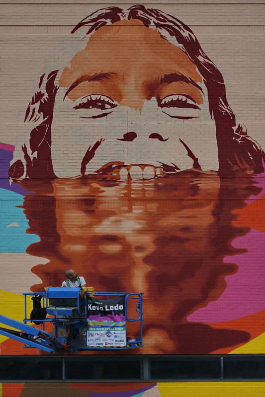 Kevin Ledo takes a look at the mural he is painting on the side of the John J. Doran School in Fall River, MA. PHOTO PETER PEREIRA