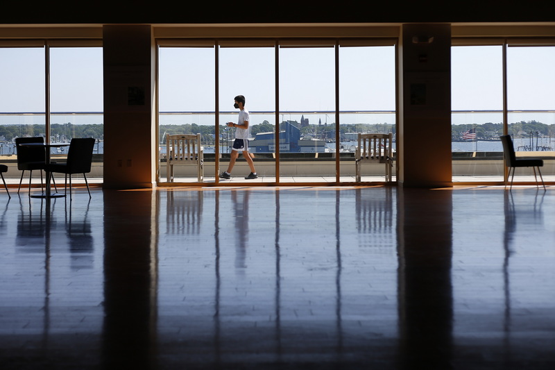 A young man walks across the windows of the Habor View Terrace at the Whaling Museum in New Bedford, MA. PHOTO PETER PEREIRA