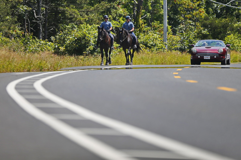 Two mounted State Police officers make their way down Route 88 in Westport, MA near the entrance to Horseneck Beach.  PHOTO PETER PEREIRA