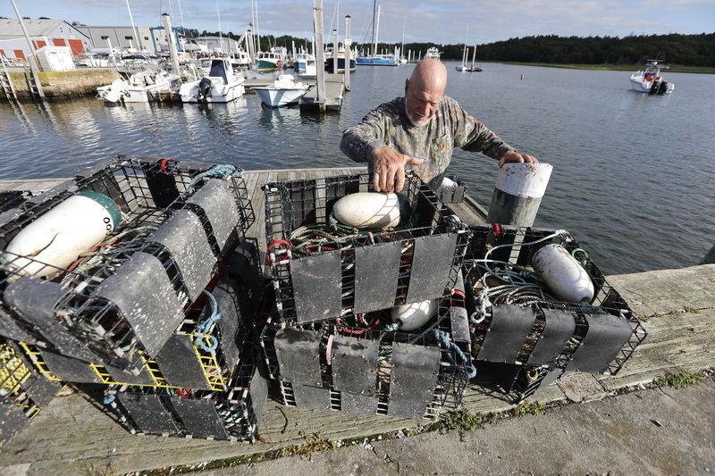 Karl Drake assembles his conch traps onto the dock in Marion, MA before loading them onto his boat. PHOTO PETER PEREIRA