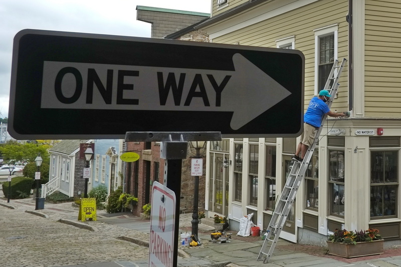 Nelson Santos displays one way to sand the trim boards of the Salt n Sole building in downtown New Bedford, MA before applying a new coat of paint.  PHOTO PETER PEREIRA