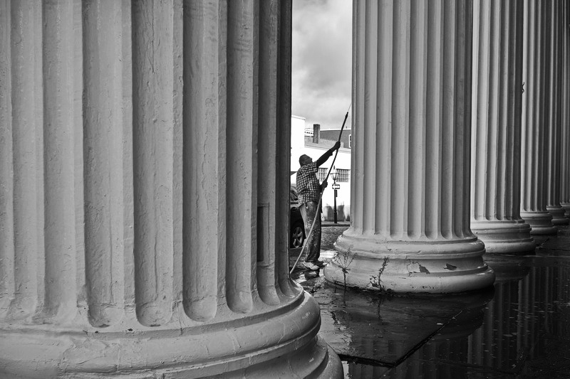 Gilbert Brown of Big Dog Painting, washes the colonnade of the J. J. Best Banc & Co building on N Water Street in New Bedford, MA before repairing the column bases of the historic building. PHOTO PETER PEREIRA