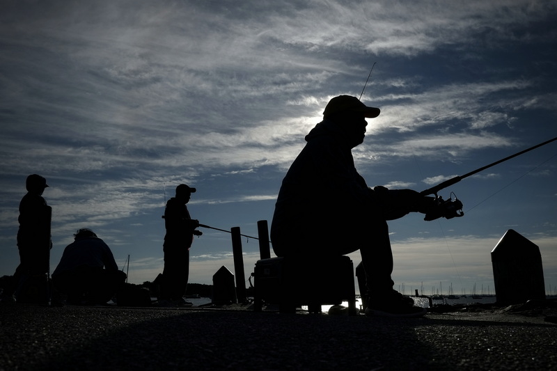 People enjoy some early morning fishing from the wharf in Mattapoisett, MA. PHOTO PETER PEREIRA