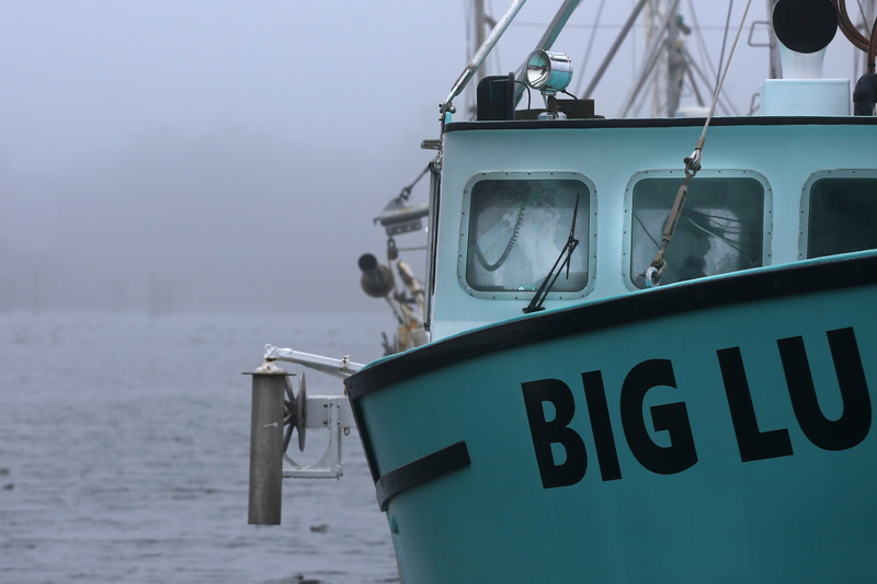 A fisherman can be seen through the windows of the wheelhouse of the lobster boat Big Lu docked in Westport, MA on a foggy morning.  PHOTO PETER PEREIRA