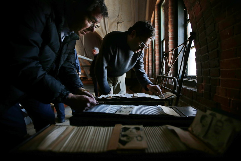 Robert Rocha Jr., Associate Curator of Science and Research at New Bedford Whaling Museum and D. Jordan Berson, Director of Collections, take a closer look at Ash Street jail records dating to between 1910 and 1940 which are stored in the jail's attic space and which the Whaling Museum are considering adding to their collections.  The Ash Street jail in New Bedford, MA is the oldest operational jail in the country and is in cosideration for closure.  PHOTO PETER PEREIRA