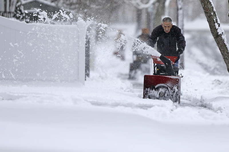 Don Perry uses a snowblower to clear the snow from the sidewalk in front of his home in New Bedford, MA as residents dig out of the only snow storm of the season.  PHOTO PETER PEREIRA