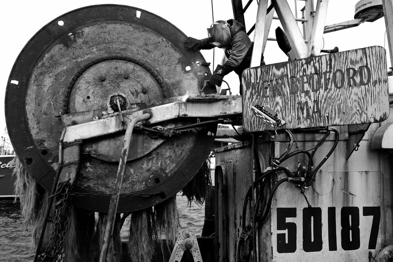 Ronaldo Guzman of Luzo Welding welds a supporting piece to the drum of a fishing boat in New Bedford, MA.  PHOTO PETER PEREIRA