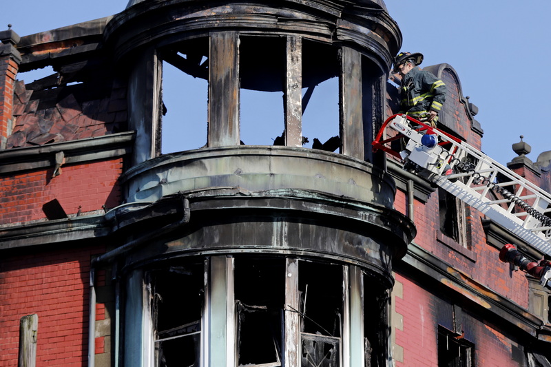 New Bedford firefighters search for still unaccounted resident who lived in apartment building on Acushnet Avenue which caught fire yesterday. PHOTO PETER PEREIRA