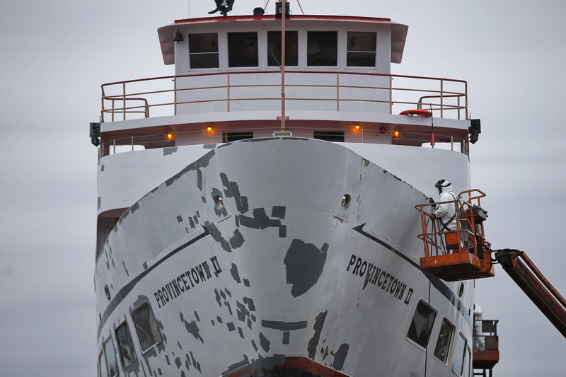 A shipyard worker grinds the areas that need repairs on the bow of the Provincetown II ferry, before applying a new coat of paint at Fairhaven Shipyard in Fairhaven, MA. PHOTO PETER PEREIRA