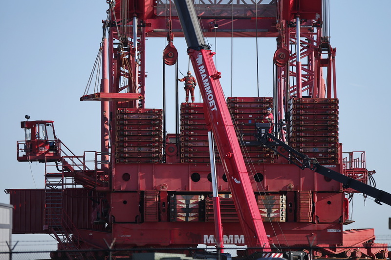 Mammoet crews install the counterweights of the mammoth crane being constructed at the New Bedford Commerce Terminal in New Bedford, MA for future offshore wind turbine assembly. PHOTO PETER PEREIRA