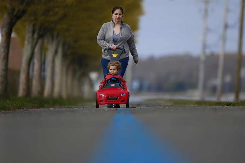 Casey Cabral and her son Maxwell Cabral, 1, go for a walk along the Blue Lane walk path around the south end of New Bedford.