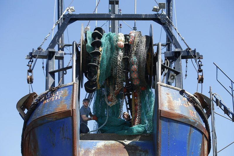 Fishermen remove the groundfish nets from the drum of their fishing boat undergoing repairs at the Fairhaven Shipyard in Fairhaven, MA. PHOTO PETER PEREIRA