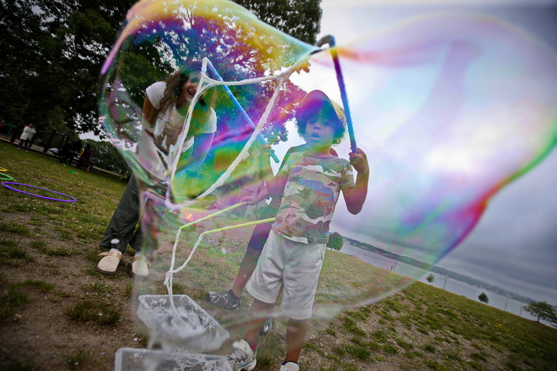 Adriane Perdomo, 7, blows a soap bubble at the Play in the Park program which kicked off today at Hazelwood Park in New Bedford, MA. PHOTO PETER PEREIRA