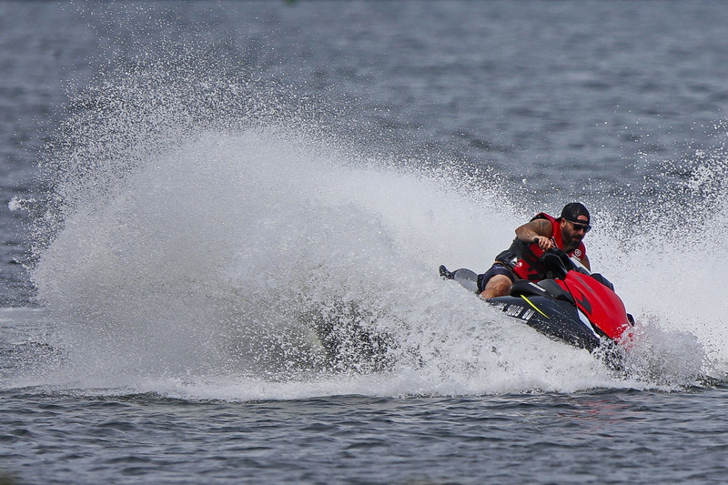 A man sends water spray into the air as he enjoys a day of jetskiing in the south end of New Bedford, MA. PHOTO PETER PEREIRA