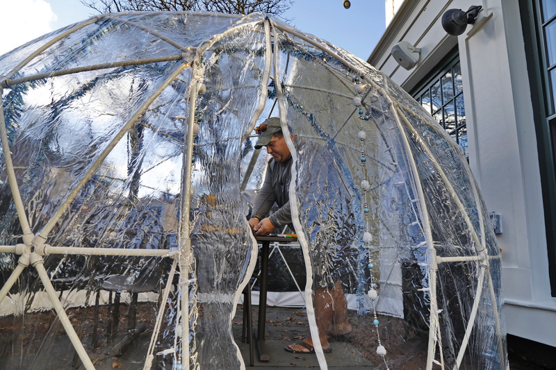 Tom Consoli makes repairs to the outside 'igloo' installed in front of Cultivator Shoals on Union Street in New Bedford, MA after high winds blew the top off over the weekend.  PHOTO PETER PEREIRA