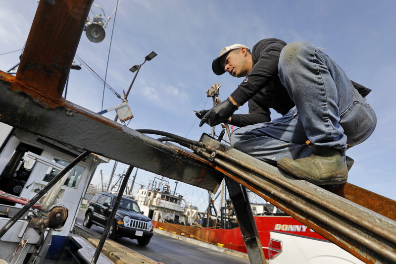 Andrew Spalt climbs the side of the new hydraulic dredge ramp he is installing aboard his boat Miss Emma.  The new ramp will help in stabilizing the ship during rough seas and will be used for the first time when he heads back out to sea from New Bedford next week.  PHOTO PETER PEREIRA