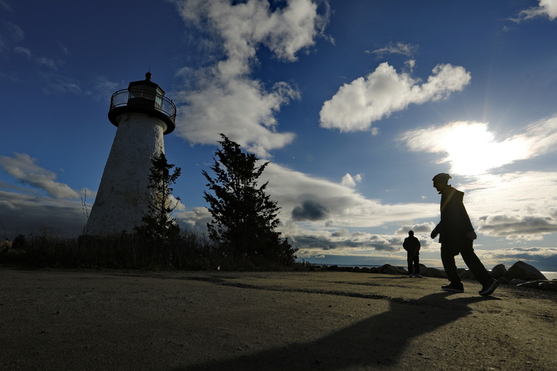 Leanore Henderson, left, and her husband Scott Henderson go for their daily morning walk around the Ned's Point lighthouse in Mattapoisett, MA. PHOTO PETER PEREIRA