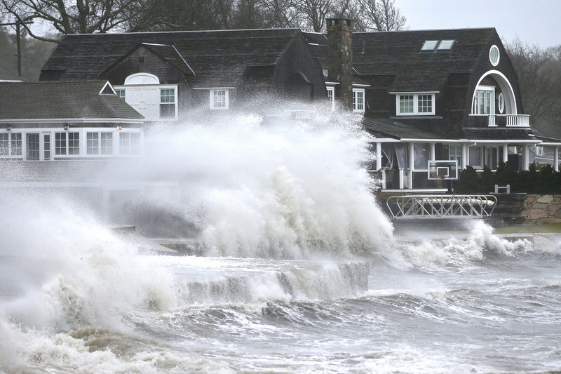 High winds drive surf into a retaining wall in front of a residence in Mattapoisett, MA as a storm makes its away across the region.  PHOTO PETER PEREIRA