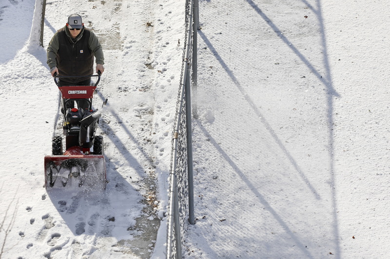 A man uses a snow blower to clean the sidewalk  on Acushnet Avenue in downtown New Bedford, MA the day after a snow storm swept over the region.  PHOTO PETER PEREIRA