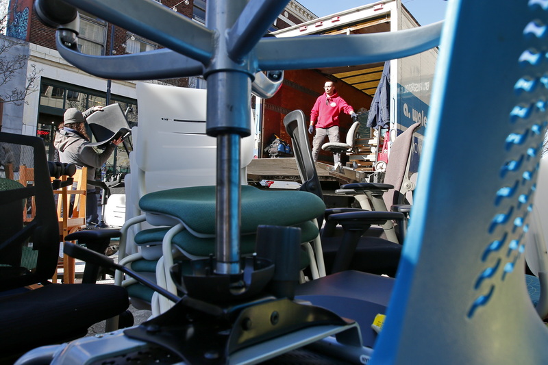 A. Walecka & Sons movers load hundreds of chairs from the downtown New Bedford Bristol Community College campus, to be moved to another location.  PHOTO PETER PEREIRA