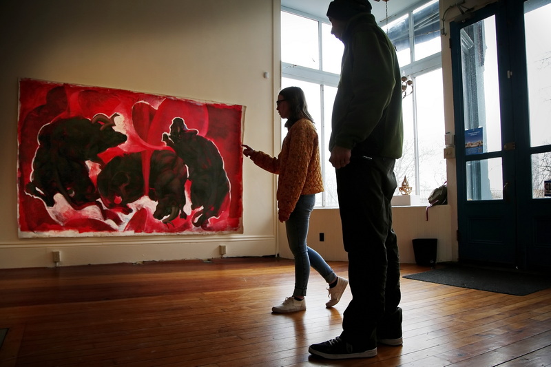 Fallon Navarro, ceramic MFA student and curator of the new Star Store Collaborative Space, works with UMass graduate student, Ali Masoumzadeh on where his 'Red Painting' will hang for the upcoming exhibit at the new gallery space on William Street in downtown New Bedford, MA in an effort to keep a downtown presence since the closure of the Star Store campus.  PHOTO PETER PEREIRA