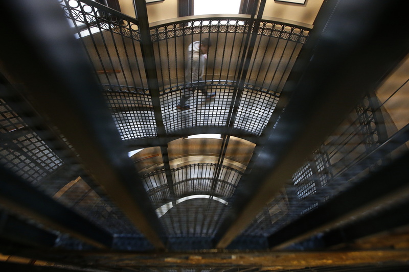 A man walks down the steps which wind around the outside of the historic elevator at New Bedford City Hall. PHOTO PETER PEREIRA