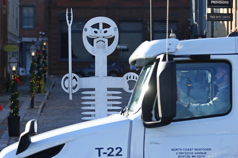 A truck driver waiting for the light on Route 18 in downtown New Bedford, MA is being watched by a scultpure by Eric Lintala.  The sculpture entitled 