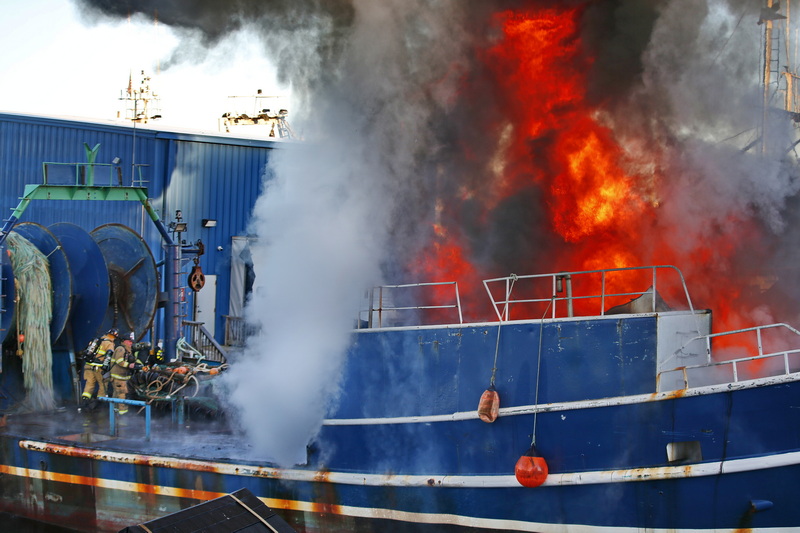 Fairhaven firefighters battle a fire which broke out inside the fishing boat Carrabassett which was undergoing repairs while docked at the bottom of Washington Street in Fairhaven, MA. PHOTO PETER PEREIRA