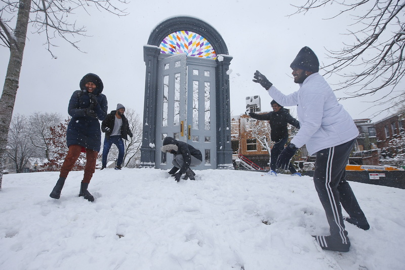 UMass Dartmouth engineering students from Hyderabad, India play with snow for the first time ever at Custom House Square in New Bedford, MA as heavy snow falls across the region. PHOTO PETER PEREIRA