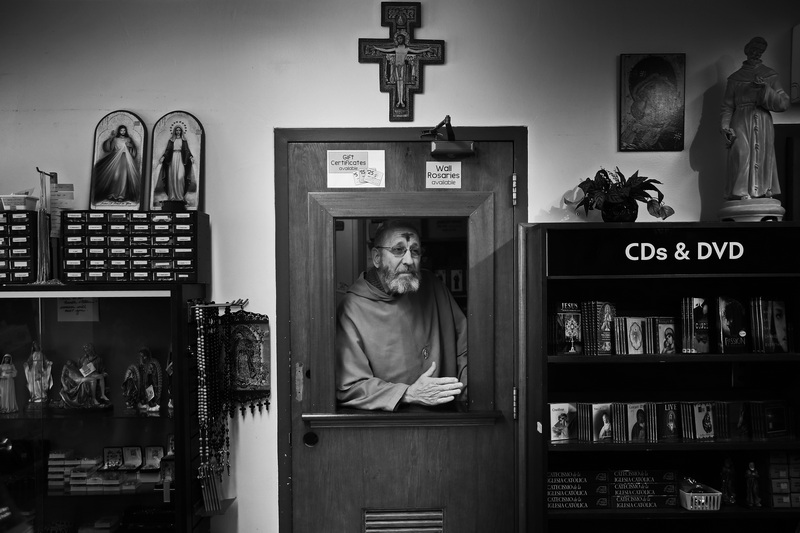 Franciscan Father Joachim speaks with people visiting the gift store at Our Lady's Chapel in downtown New Bedford, MA after delivering Ash Wednesday Mass. PHOTO PETER PEREIRA