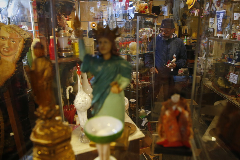 Kevin Amado looks for a few more interesting items to purchase at Cottage Antiques in downtown New Bedford, MA after finding a small baseball player made in early 1900's. PHOTO PETER PEREIRA