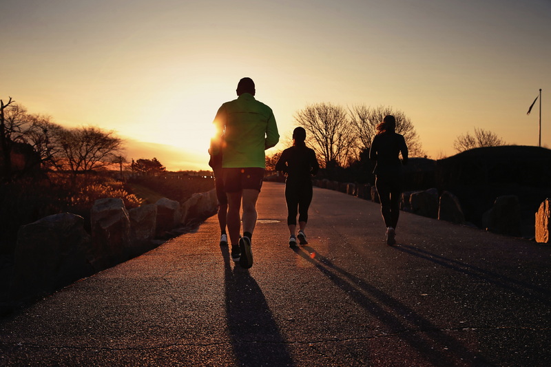 Runners make their way across the top of the hurricane barrier toward the rising sun at Fort Phoenix in Fairhaven, MA. PHOTO PETER PEREIRA