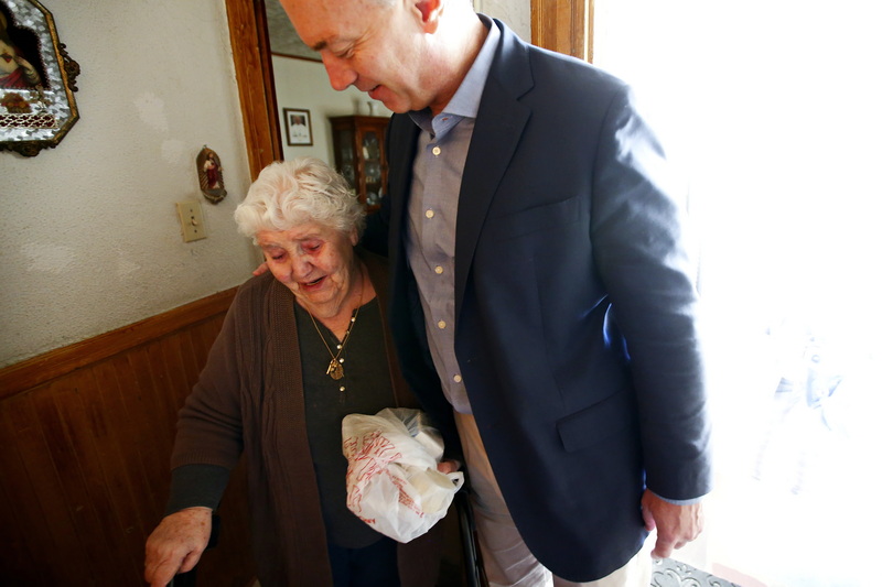 Maria Amaral is overcome with emotion upon realizing that Mayor Jon Mitchell is the one delivering her meal today as part of the Coastline Elderly's Meals on Wheels program in New Bedford, MA.  Mrs. Amaral is blind and at first was not aware that her meal was being delivered by a different person today.  PHOTO PETER PEREIRA