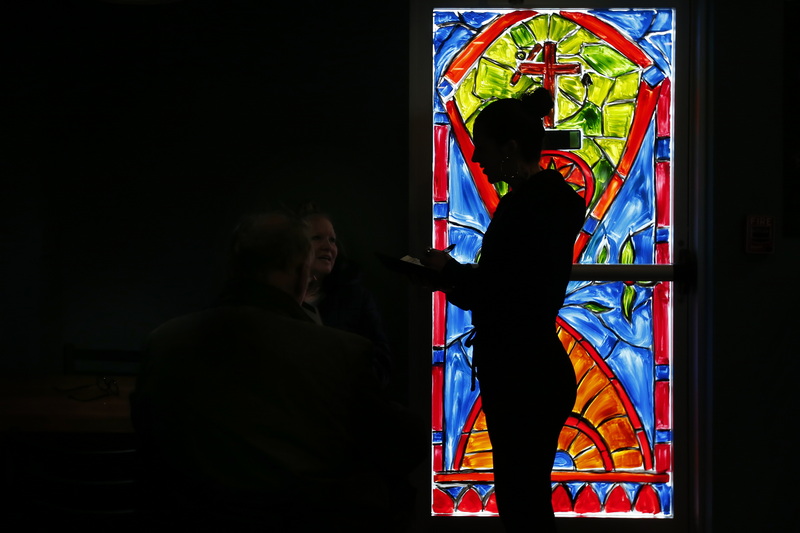 Audrey Thomson is silhouetted in front of a colorfully painted glass door of the just opened What the Taco in Mattapoisett, MA as she takes a customers lunch order.  PHOTO PETER PEREIRA