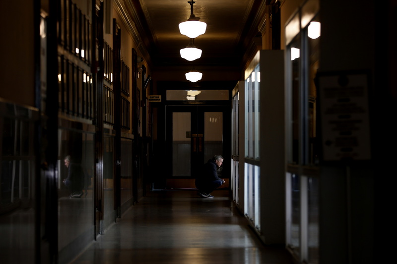 A man stops to browse the glass collection on display on the first floor of New Bedford City Hall.  This is part of a rotating collection housed in the New Bedford Glass Museum. PHOTO PETER PEREIRA