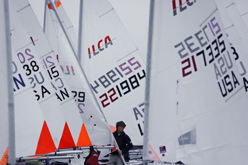 A sailor maneuvers his sail into position as he and fellow sailors competing in the ILCA North American Championships prepare their boats at the New Bedford Yacht Club in Dartmouth. The event will run between June 6th through June 9th off of Padanaram Harbor in Dartmouth. PHOTO PETER PEREIRA