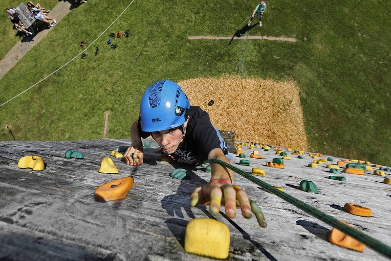 Dartmouth Middle School eighth grader, Austin Backlund, 14, reaches for a hand hold as he climbs the 40' rock climbing wall during a field trip to the Dartmouth YMCA. PHOTO PETER PEREIRA