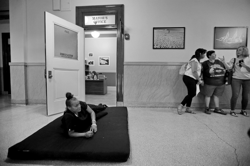 Tiffany Ellis, who has been homeless and sleeping on the streets since 2021, sets up a bed in front of the Mayors office in New Bedford City Hall after members of United Interfaith Action of Southeastern Massachusetts delivered a series of letters to Mayor Jon Mitchell adressing the housing crisis of high rents, rising home prices, and increasing homelessness. PHOTO PETER PEREIRA