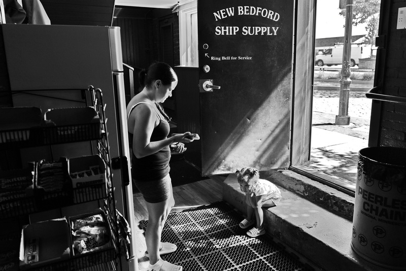 A woman and young girl wait for a man to finish making his purchases at New Bedford Ship Supply before he heads out to sea from New Bedford harbor. PHOTO PETER PEREIRA