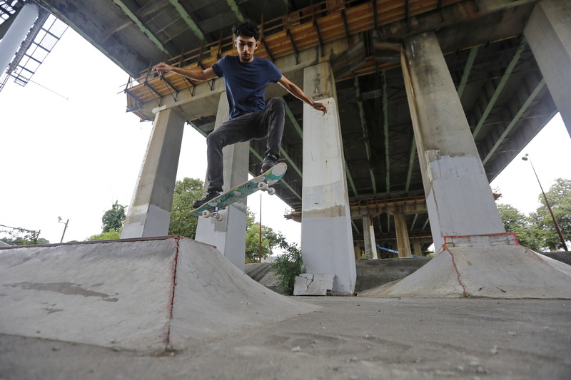 Tyler Audette flies through the air while performing a jump on his skateboard at the skate park under the Route 195 overpass in New Bedford, MA.  PHOTO PETER PEREIRA