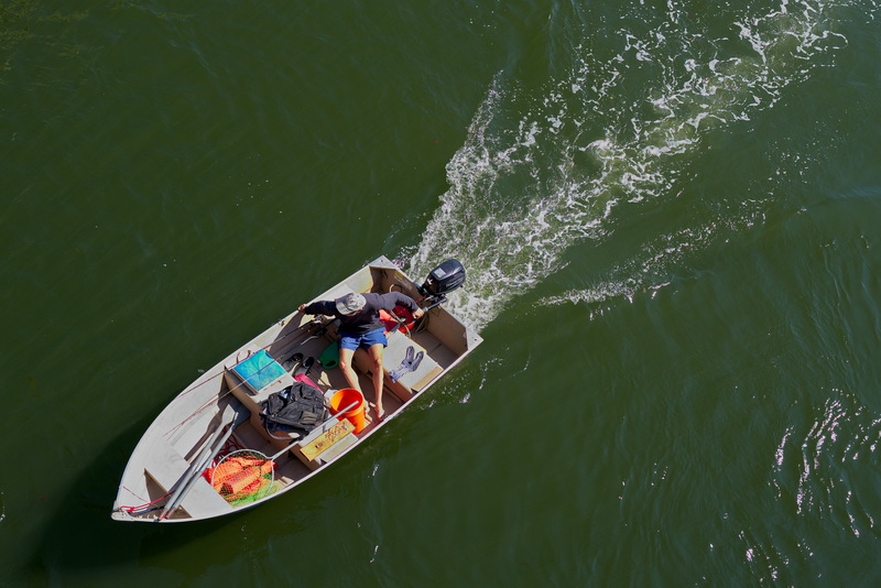 A man rides his boat as seen from the Route 88 bridge over the Westport River in Westport, MA.  PHOTO PETER PEREIRA