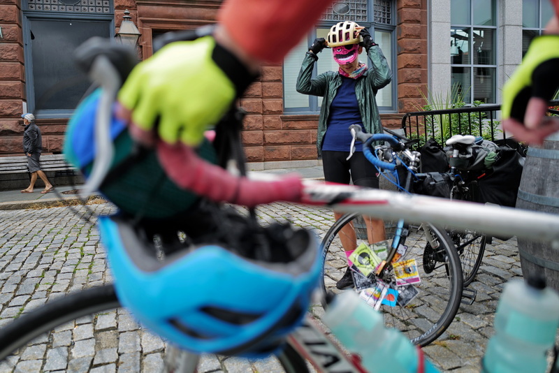 Adela Wagner puts her helmet on over a pirate themed cycling cap, as she and two other riders make a stop in New Bedford, MA for lunch during a ride from Providence, RI to Provincetown, MA over the course of three days. PHOTO PETER PEREIRA