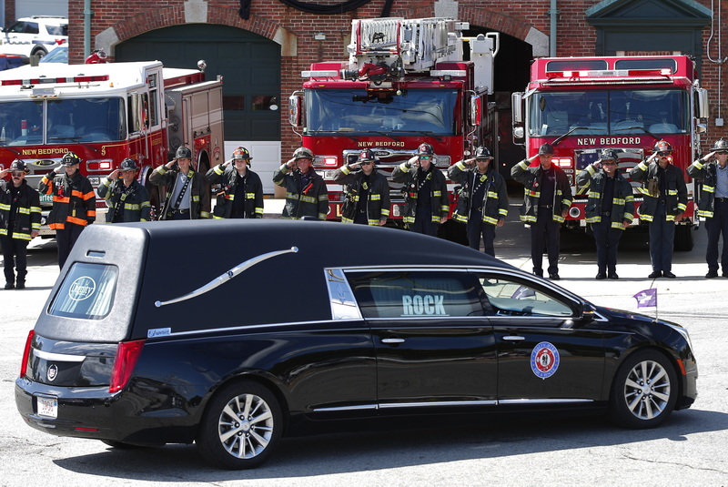 Station 9 firefighters salute the hearse carrying New Bedford firefighter Matthew Forand who died while on duty.  Station 9 was firefighter Forand's base. PHOTO PETER PEREIRA