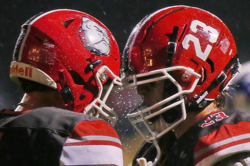 Water drops go flying as helmets collide when ORR's quarterback Gavin Martin and wide receiver Hunter Horsey celebrate a big run by Martin during the Fairhaven win against ORR on Friday night football in Mattapoisett, MA. PHOTO PETER PEREIRA