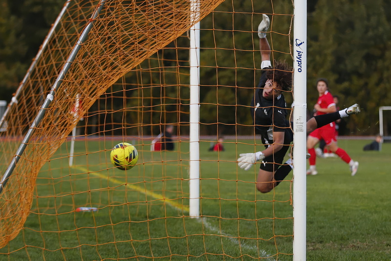 Voc-Tech goalie Christian Alturas can do nothing but look at the ball go into the back of the neck after a fantastic floating ball shot by ORR's Colin Mello (seen in background) during the Old Rochester Regional versus Voc-Tech boys soccer game in Mattapoisett, MA. PHOTO PETER PEREIRA