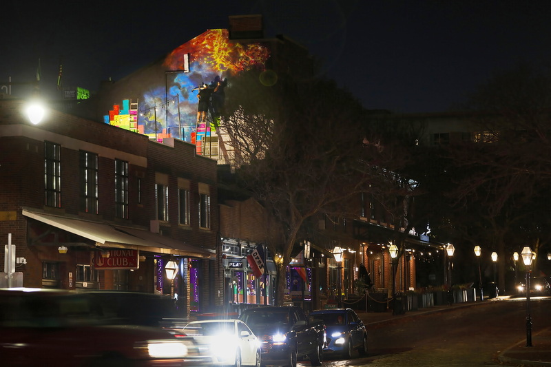 Brian Tillett paints into the night high above Union Street in downtown New Bedford, MA, as he works on a mural on the upper section of Play Arcade titled, The Final Piece.  The mural consists of lone Tetris piece representing New Bedford's play in the artistic growth in Massachusetts while the cosmic background the vast creative options for the local art community.  PHOTO PETER PEREIRA