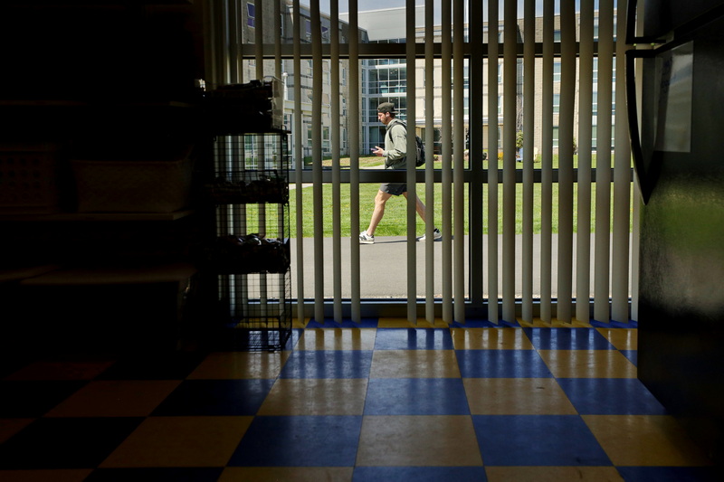 A student walks past the Woodland Commons building where the Jeanne's Cupboard food pantry at UMass Dartmouth is located to help students in need. PHOTO PETER PEREIRA